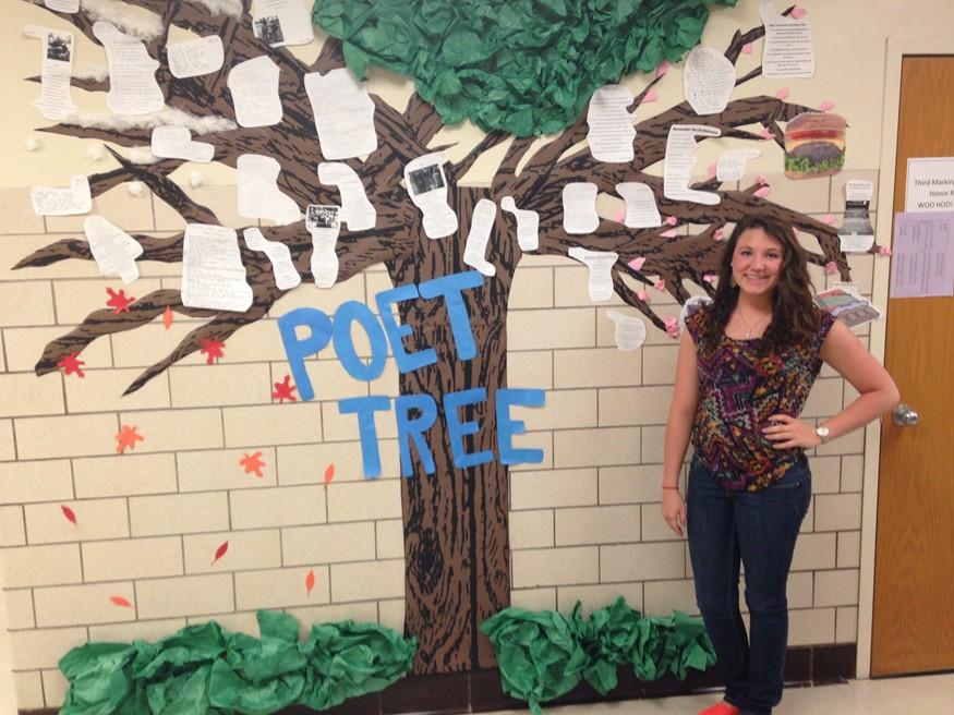 Junior+Rachel+Harris+poses+with+the+Poet-TREE+she+designed+with+student+teacher+Hannah+Sollenberger.