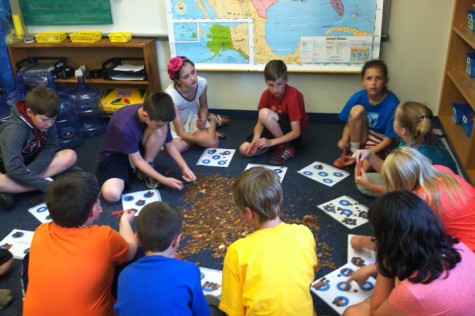 Fourth grade students from Tommie Murrays class work together to count the change collected at the elementary school for their project  “Change Changes South Sudan.