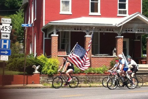 One of the event's organizers, Doug Roseberry leads the way with the Stars and Bars.