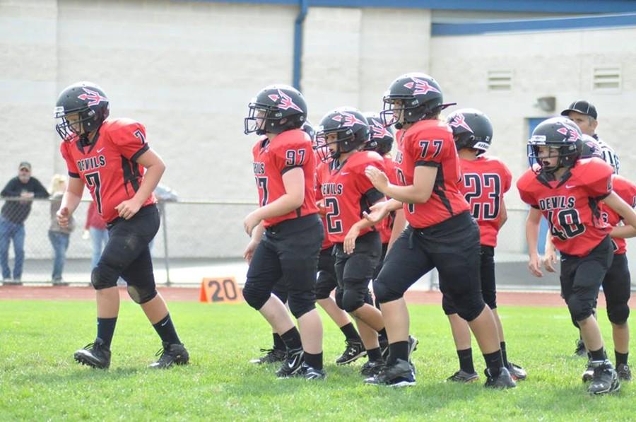 The North Side Red Devils  break the huddle in their game Sunday against Tyrones Eagles.