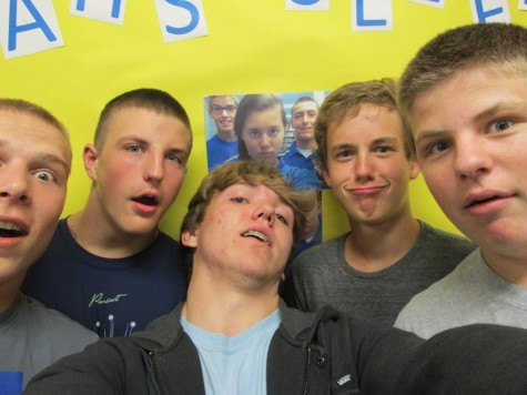 Library helpers Zach Mock, Nate Claar, Cody Campbell, Noah Burns and Jacob Hoover snap a selfie in front of the librarys new selfie board.
