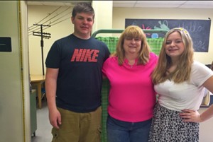 School nurse Kelly Hoover flanked by sophomore Jacob and junior Emily.