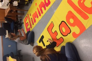 Juniors Maddie Miller and Shaniah show their spirit by making the banner