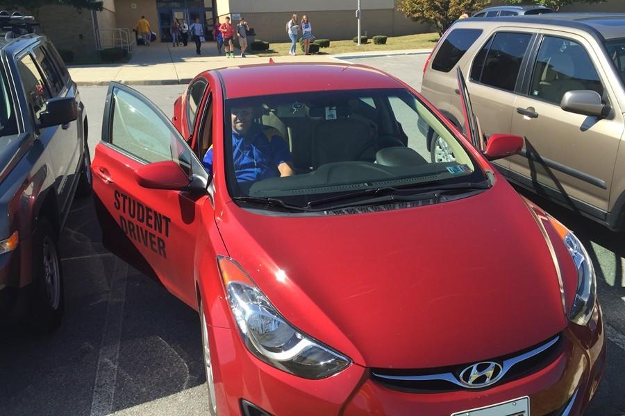 Mr. Hughes in the new student car.