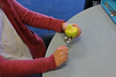 One freshman hacks apart an apple just to pass the time.