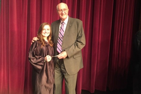 Cassidee Reiter receives her award check from Donald Mills of the B-A Lions Club. Cassidee won the club's Veterans Day writing contest with her poem about PTSD.