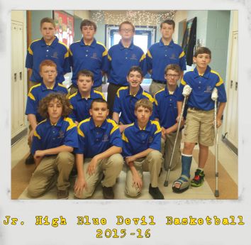 Members of the junior high basketball pose on a game day.