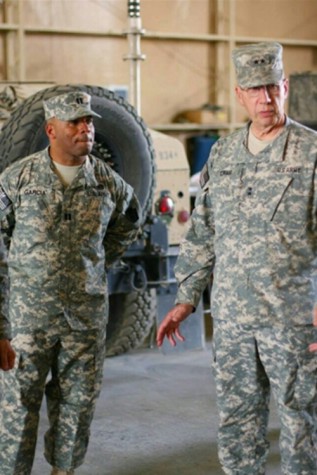 Comanche Garcia listen intently to General Wesley Craig during a visit to Kuwait.