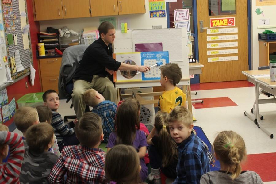 Mr. Koleno works on learning days of the month with kindergarten students at Myers.