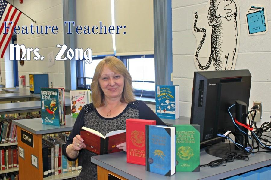 Mrs. Zong poses with her favorite books during Read Across America Week.