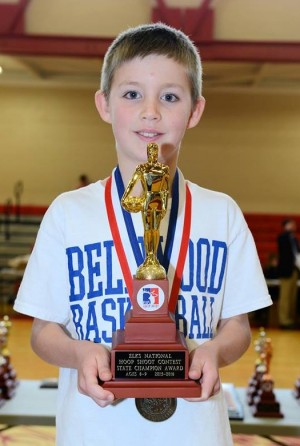 Holden Schreier lifting the hardware after his Hoop Shoot victory.