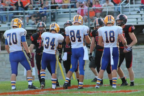 Captains Jarryd Kissell, Duke Brunner, Ryan Moore, and Ethan McGee shake hands after the coin toss to start the Backyard Brawl.