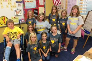 Mrs. R.Miller and some elementary students are showing their support for Maddie by wearing Bellwood loves Maddie t-shirts. 