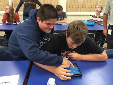 BAMS students help each other during the iPad deployment.