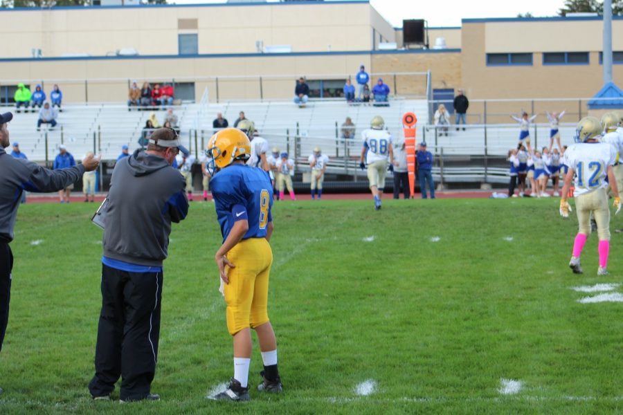 Coach Burch sends in a play with quarterback Trevor Miller.