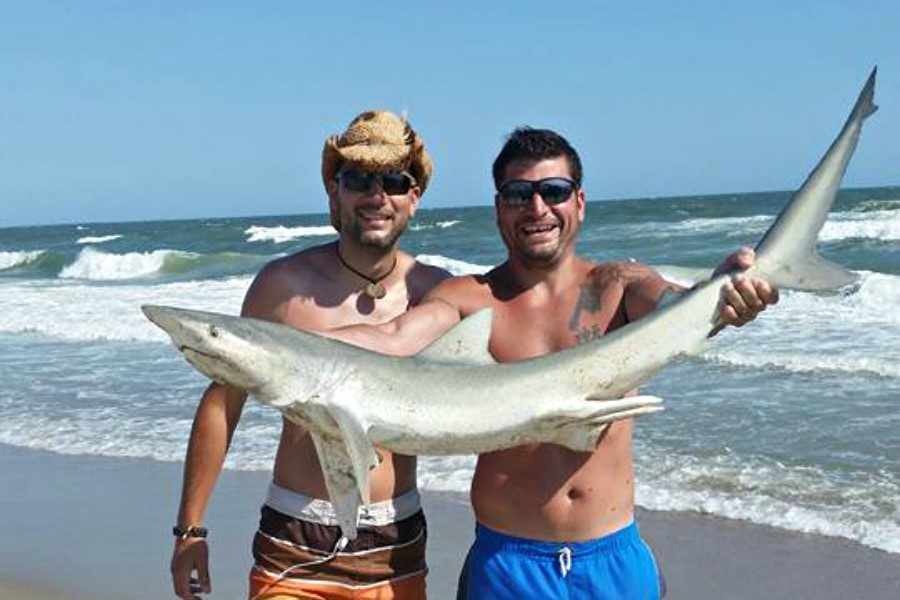 Mr. Plummer (left) and his brother Matt fished fort sharks every day at the beach last summer.