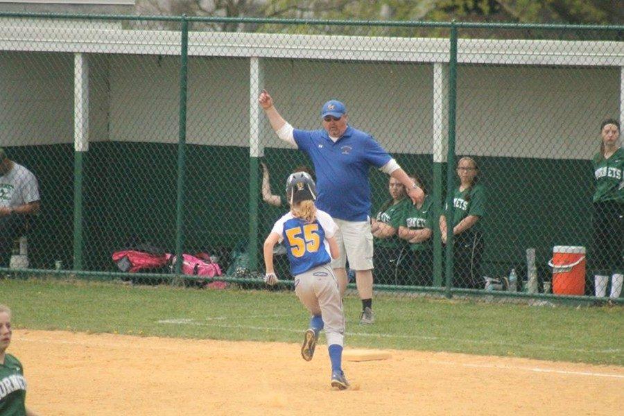 Ashtyn Payne rounding third with her father coaching along.