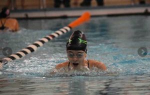 Gwen Daughterty races to the finish line in the breast stroke.