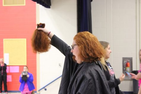 Mrs. Murray had 12 inches of hair cut off at the Childhood Cancer Awareness Week assembly at Myers. 