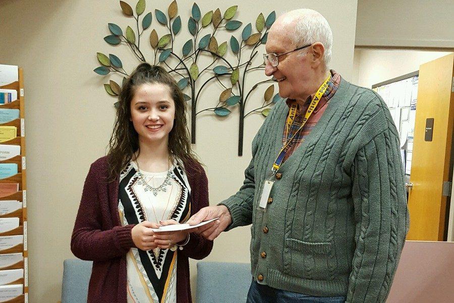 Giovanna Caracciolo accepts her award from Lions Club president Don Mills.