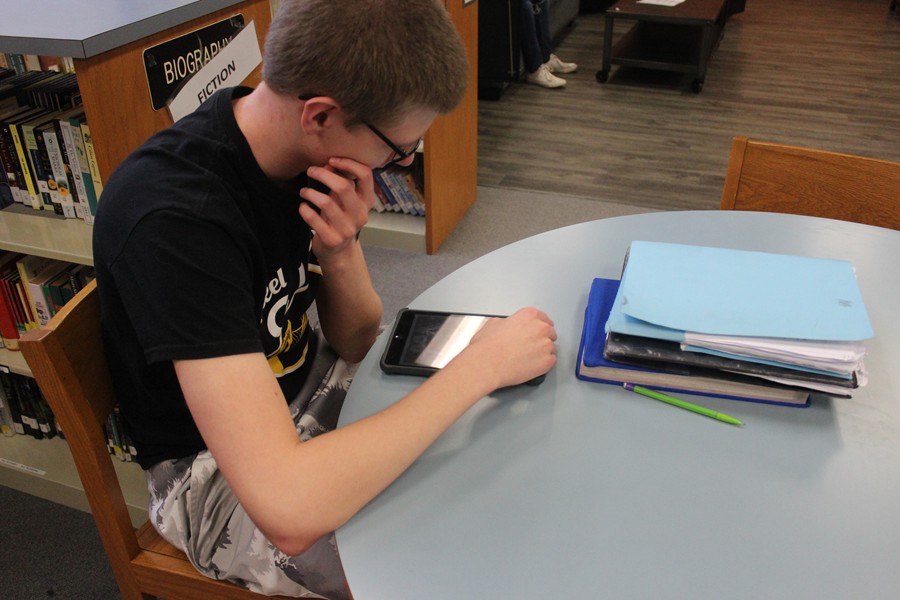 Trevor Crucial works on his iPad in the media center.
