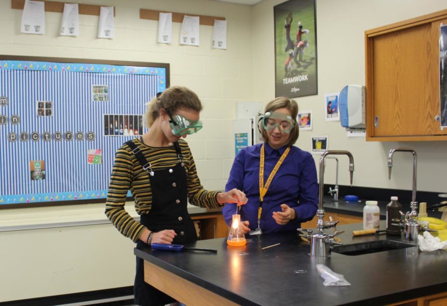 Ms. Carrie Clippard works with Brenin Abbot on a chemistry experiment. Ms. Clippard is happy to hear of an increased emphasis of STEM funding.