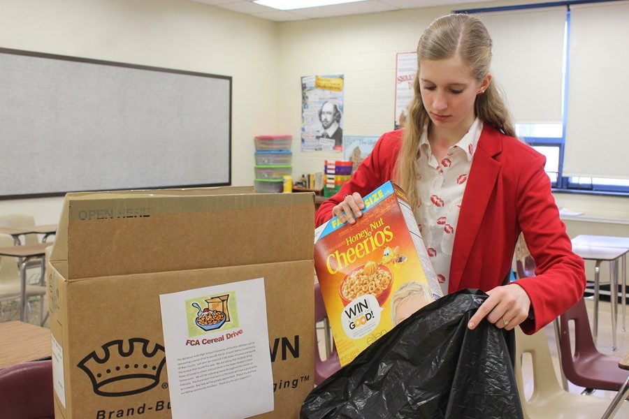 FCA+member+Cazen+Cowfer+collects+cereal+boxes+from+classrooms.+The+group+is+hoping+to+collect+more+than+1%2C300+boxes+of+cereal+in+its+annual+drive+to+benefit+the+St.+Vincent+DePaul+Food+Kitchen.