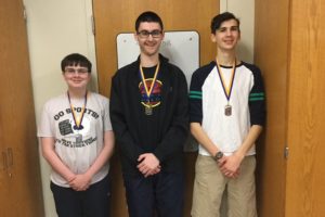 Zion Poe, center, was crowned the Chess Club tournament champion with a win in the championship finals. Pictured with him are runner-up Phillip Chamberlain (left) and third-place finisher Quintin Nelson (right).