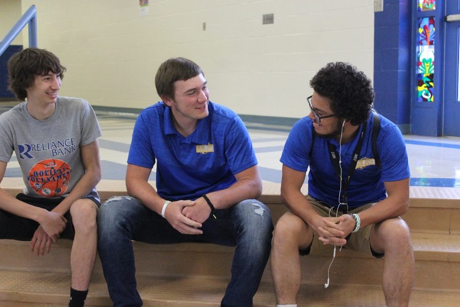 Jordan Moore (center), talks with Mason Yingling and Alex Frederick in school the day of his return to the gridiron. Jordan suffered a broken pelvis and other injuries from a near-fatal car crash in May.