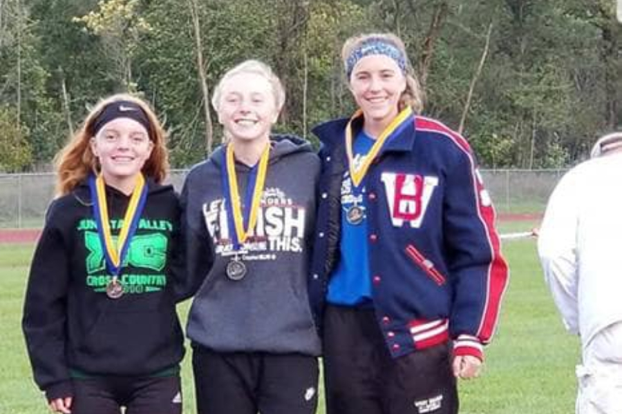 Jenna Bartlett (center) poses with Juniata Valley's Morgan Hess and West Branch's Hailey Prestash. The trio took the top three spots at the ICC cross country meet yesterday, with Bartlett earning silver.