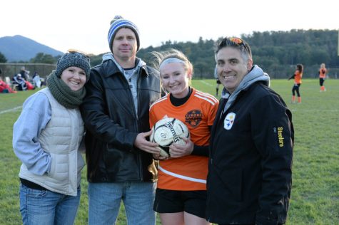 Riley DAngelo celebrates her record-setting goal with her parents and coach.