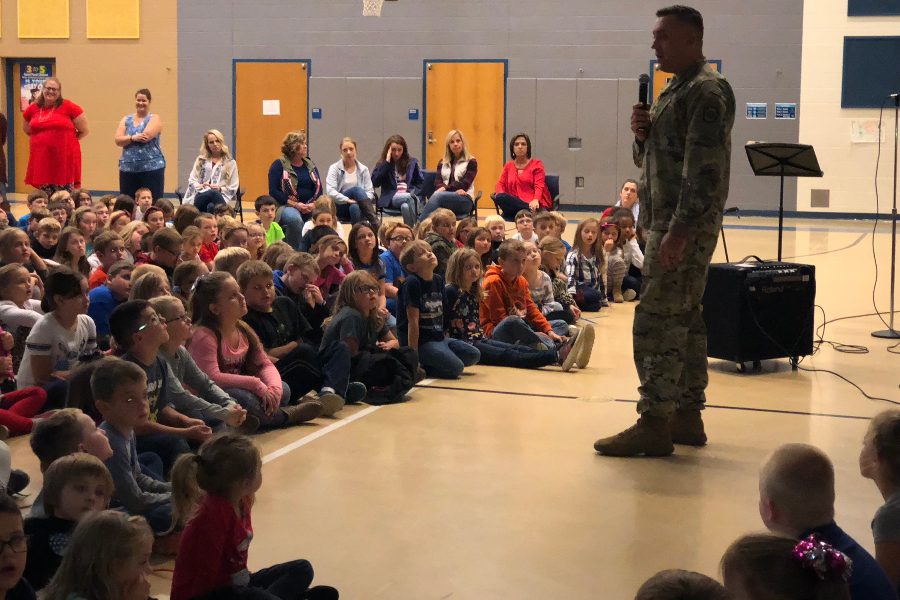 Sergeant Michael Smith , a local recruiter for the Army National Guard,  speaks to Myers students at their Stockings for Troop kickoff rally.