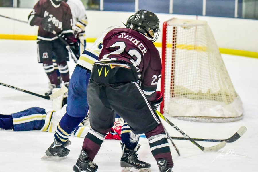 Aiden Reimer goes hard to the net.