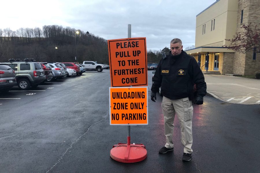 Security officer Tim Mercer helps to direct traffic in the high school parking lot.