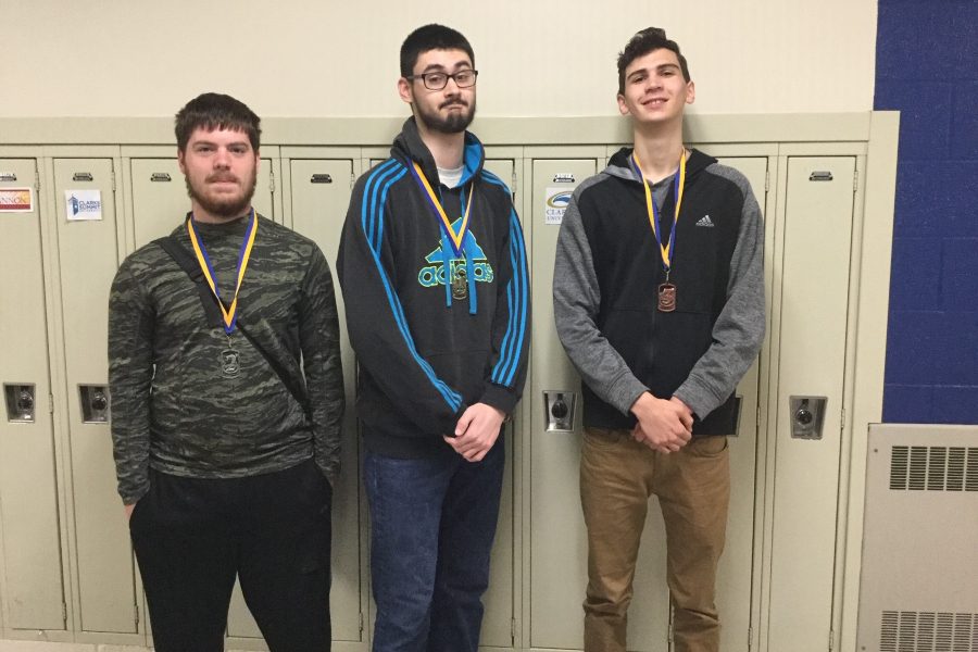 Chris Klein, left, finished second to Zion Poe, center, in the annual Chess Club tournament. Quntin Nelson, right, placed third.