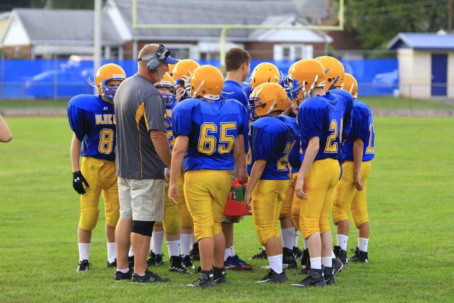 Coach Erickson gathers his junior high team for a word last season,.