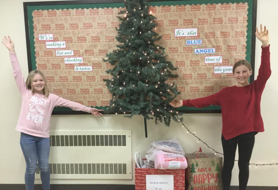 Fifth grade students show off the Blue Angels tree located in the middle school.