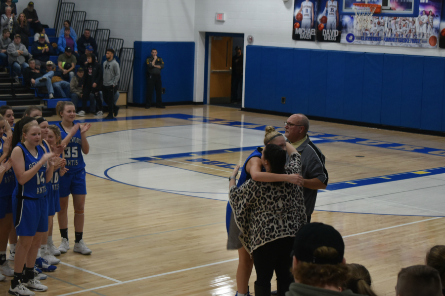 Alli Campbell hugs Coach Jim Swaney and Kylie Longo after breaking the Blair County scoring record.