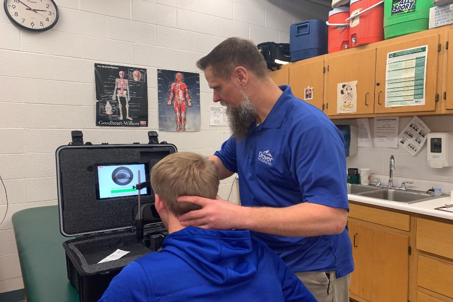 Bellwood-Antis athletic trainer Jesse Glass running concussion protocol on an athlete. 