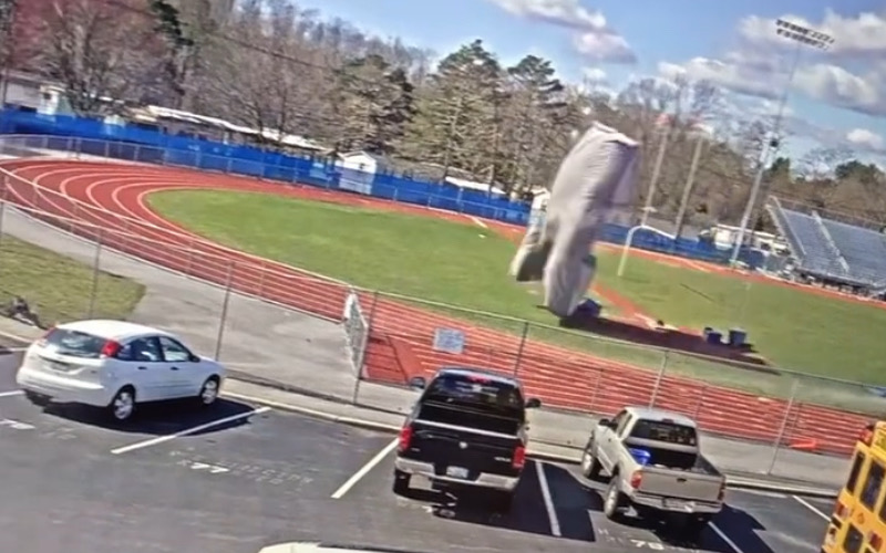 Video cameras caught the pole vault pit as it took flight in 50 mile per hour winds, headed straight for cars in the parking lot.