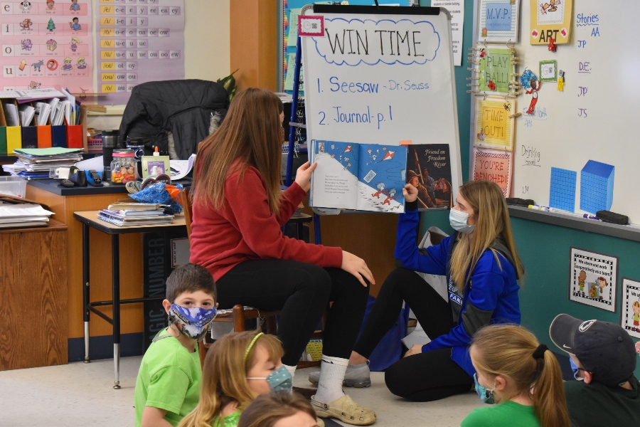 Cami Focht and Chloe Hammond read to second graders as part of Read Across America Week.