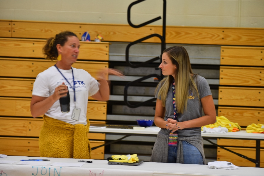 Mrs. Stinson and Mrs. Auberzinsky talk at the Renaissance table at the recent activity fair.