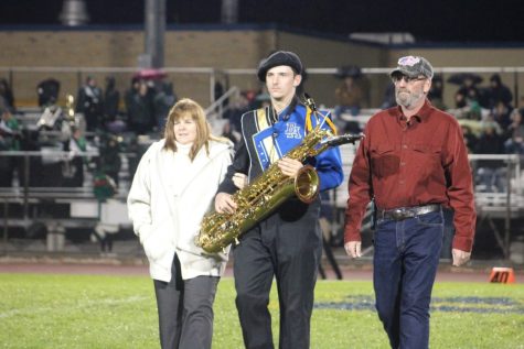 Patrick Coakley takes the field with his parents on Senior Hight. (Kimberly Bennett)