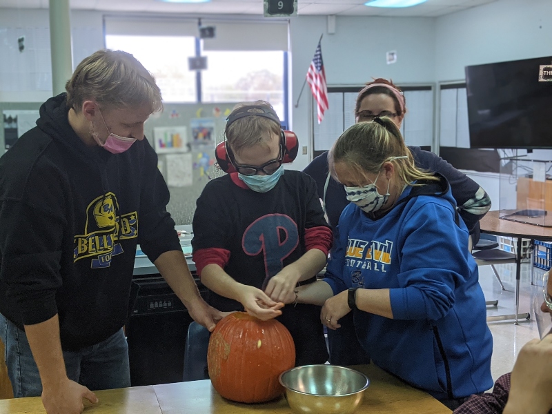 Life skills students spent Thursday carving pumpkins with football players.