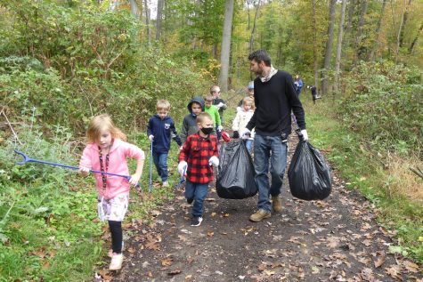 Myers teacher Mr. Dave Plummer and his students clean litter off a trail near the elementary school.