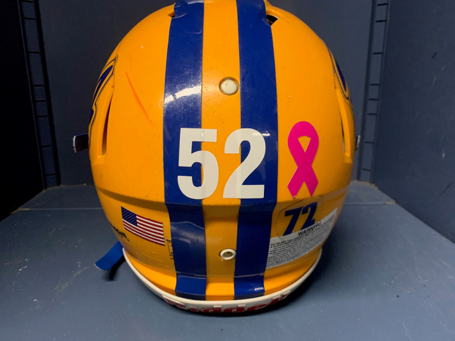 The football team has placed decals of Dominic Caracciolos number on their helmets in honor of their injured teammate.