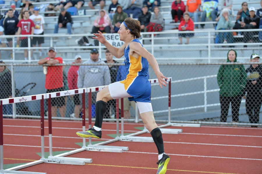 Hunter+Shawley+goes+over+the+last+hurdle+to+win+the+300-meter+race+at+the+District+6+2A+championships.