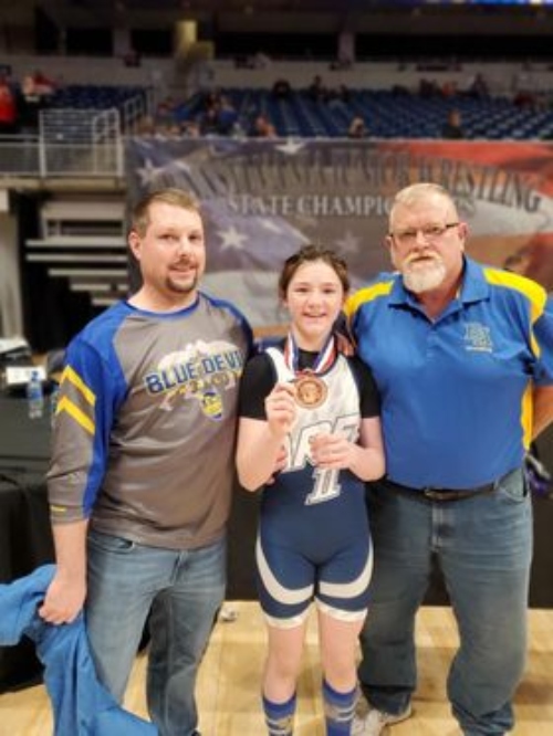 Isabel Sweet with Coach Evans and Coach Hewitt.