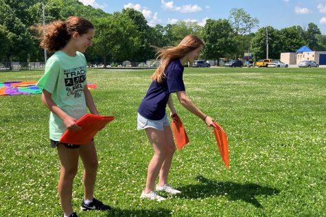 Briley Campbell and Riley Andrews set up field day activities for National Junior Honor Society.