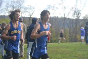 Christian Sensibaugh, running here just ahead of Daman Mills, has been the top runner for the boys cross country team this season.